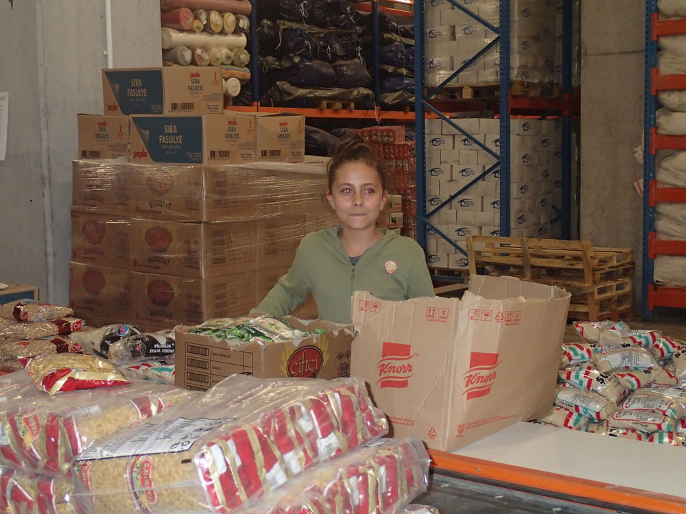 Girl sorting food into packages in Kisme Yok Mu