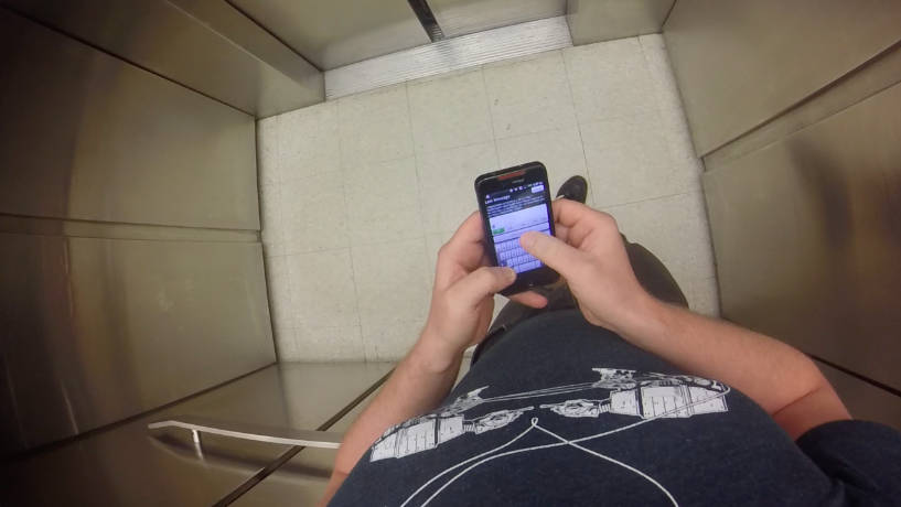 A birds-eye view shows someone texting on their phone