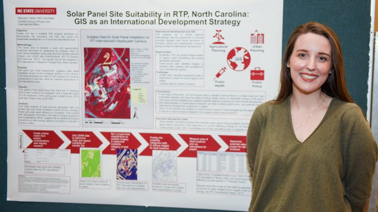 Missy Catlow stands in front of her research poster