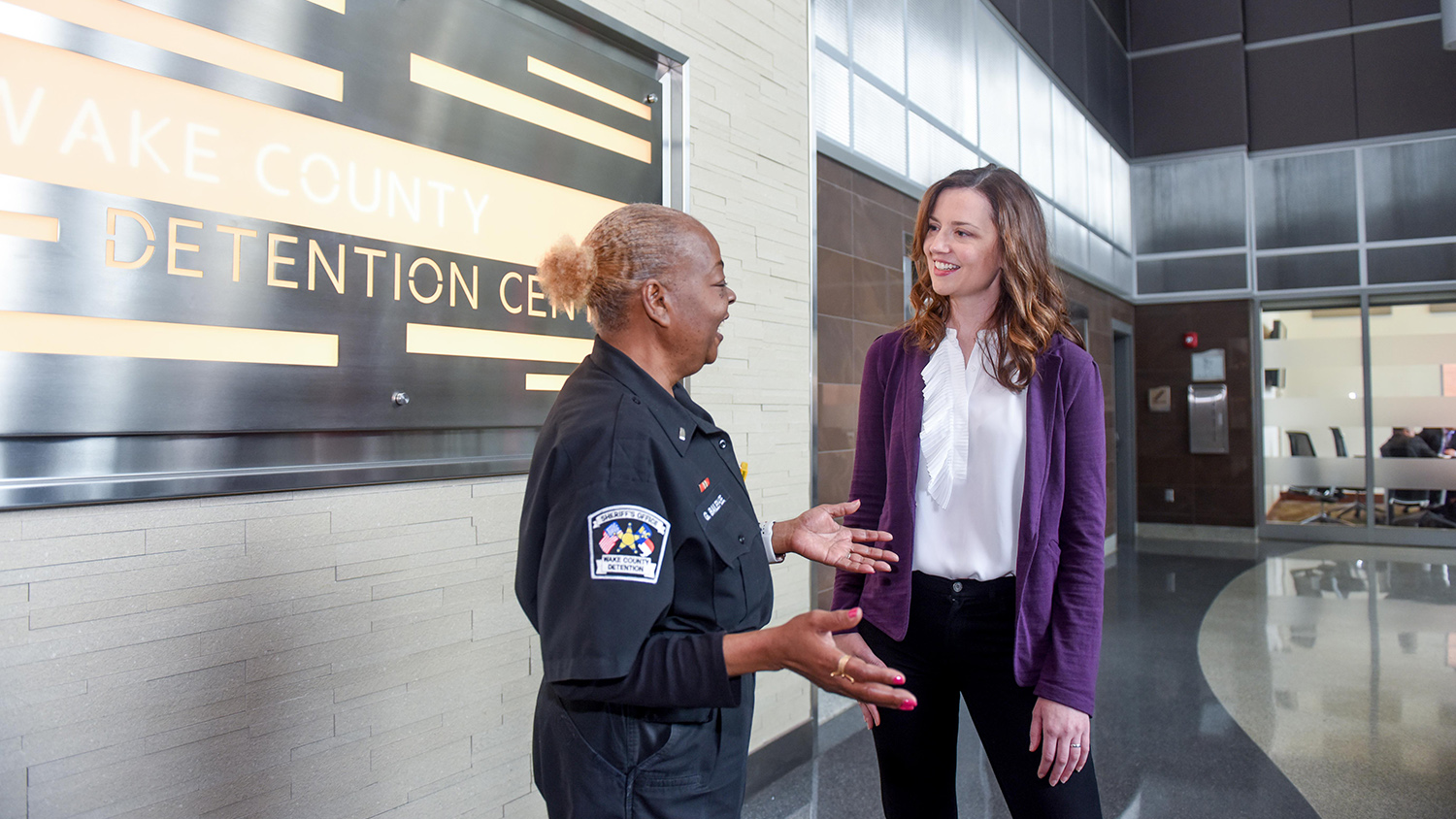 woman standing next to police officer