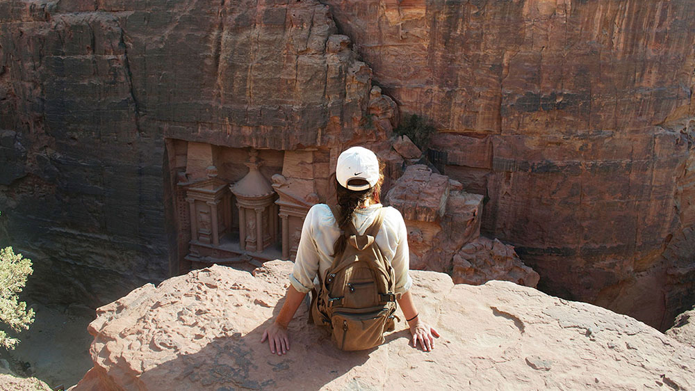 A student looks out over a ridge in Petra, Jordan.