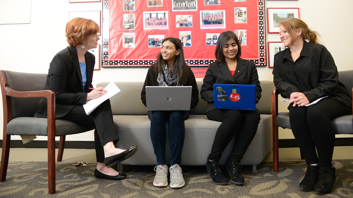 students sitting on couch with laptops