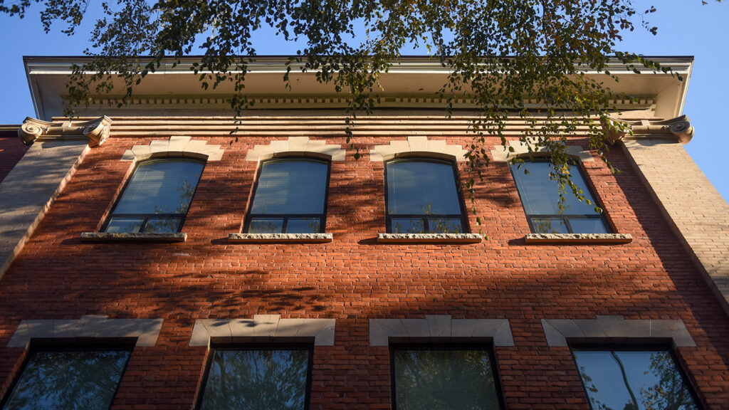 windows on brick building show reflection