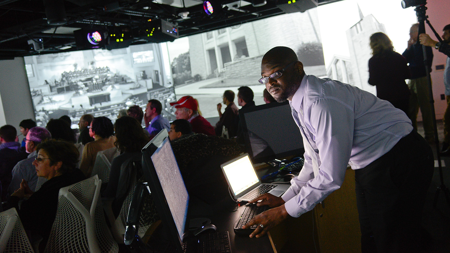 man standing at computer in visualization lab