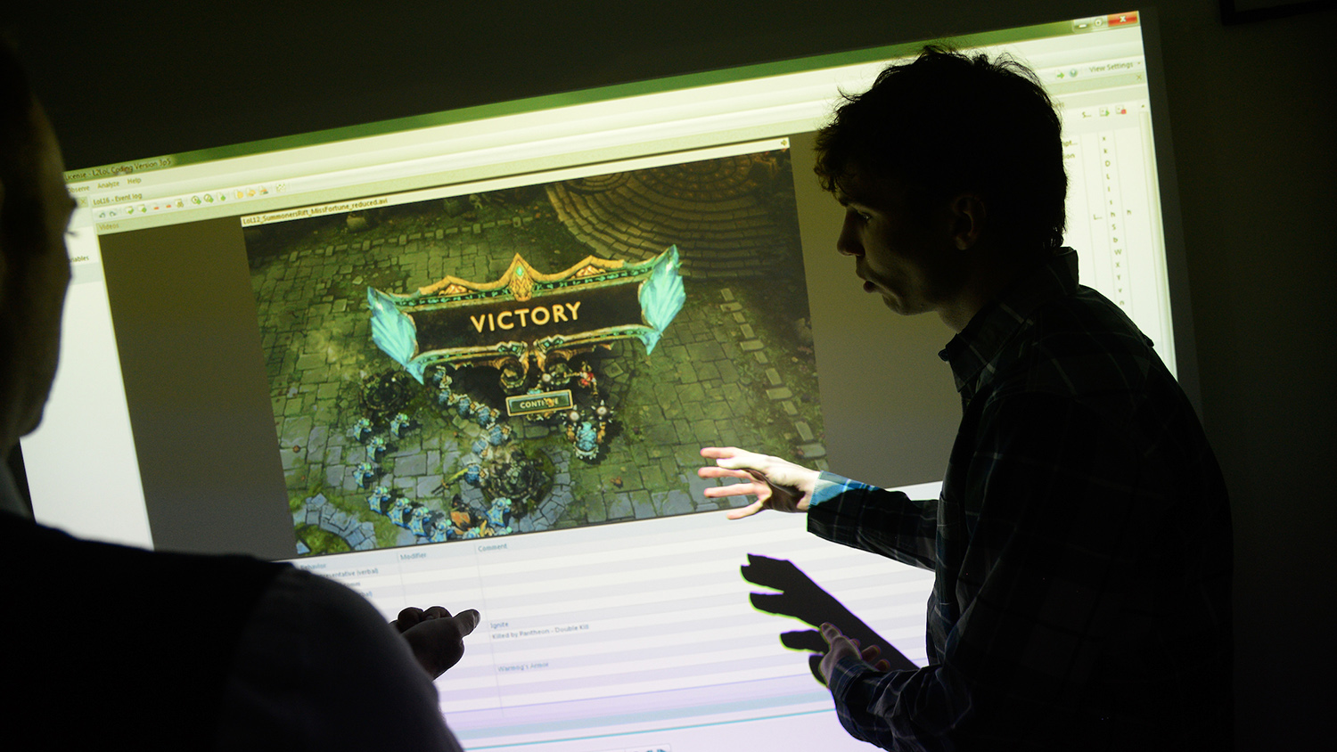 A student demonstrates his project on a large screen