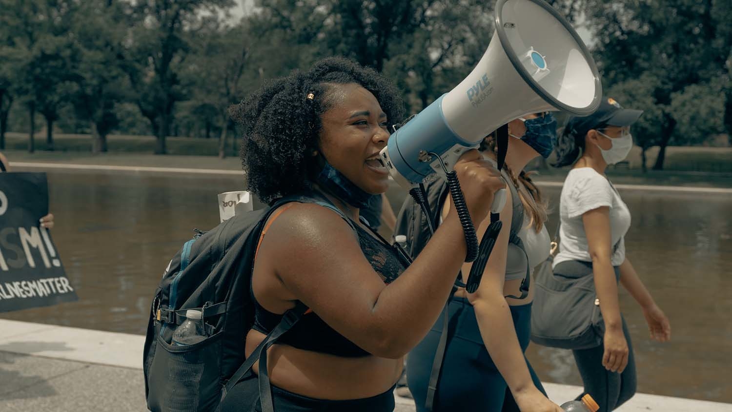 young woman speaking into a megaphone