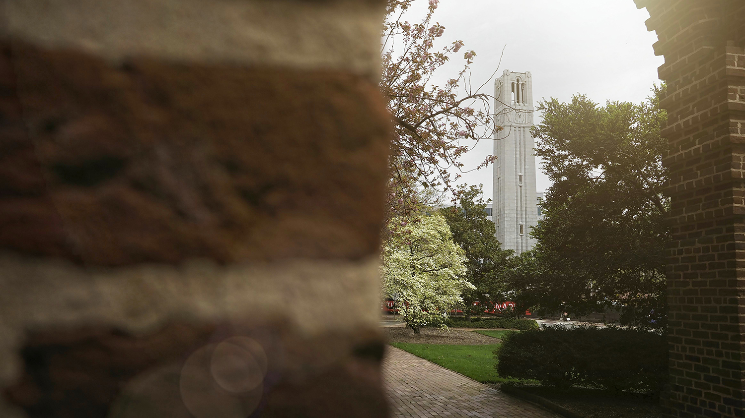 A view of the Belltower in spring as seen through an arch of bricks.