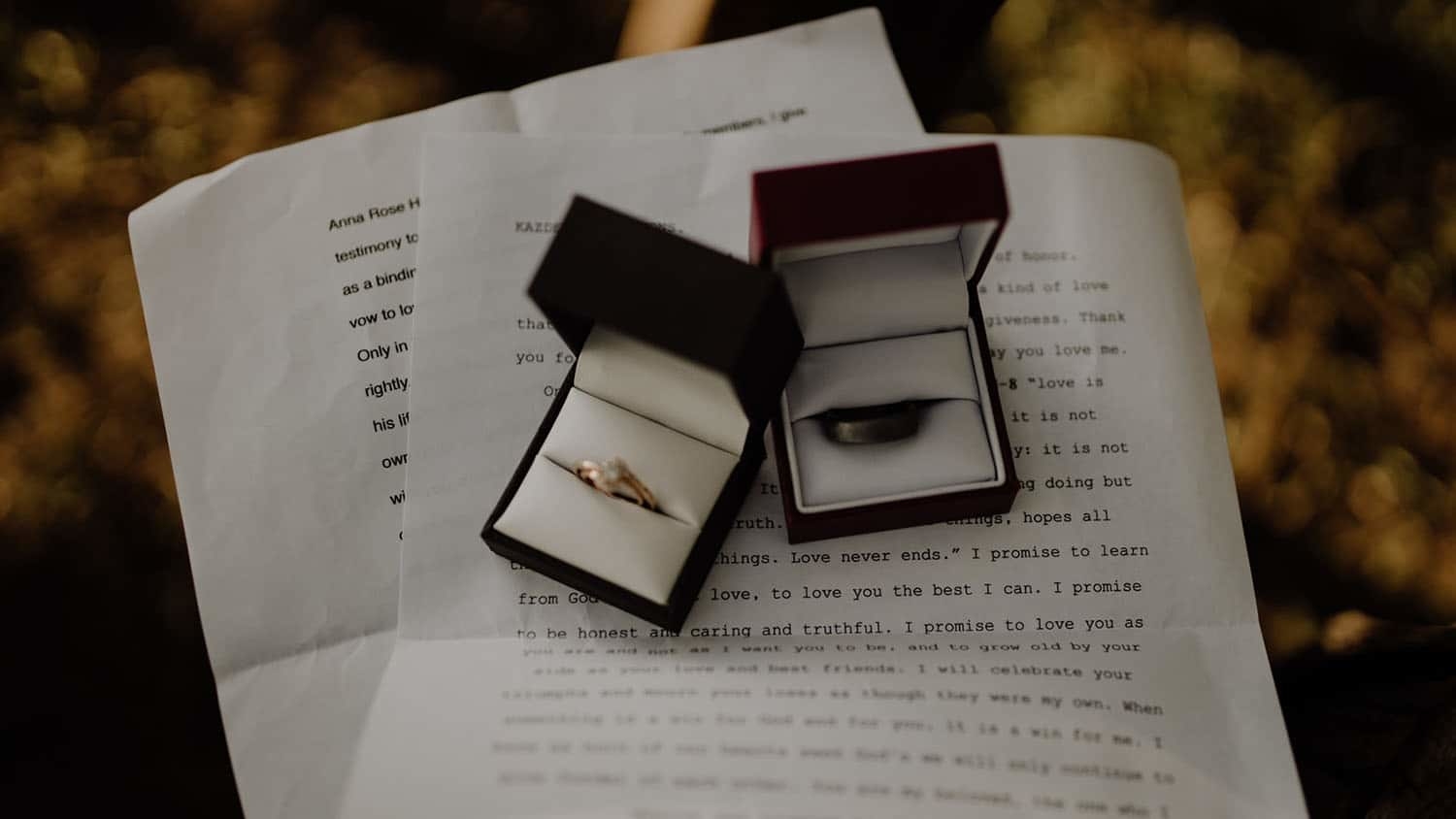 wedding rings resting on top of a written document