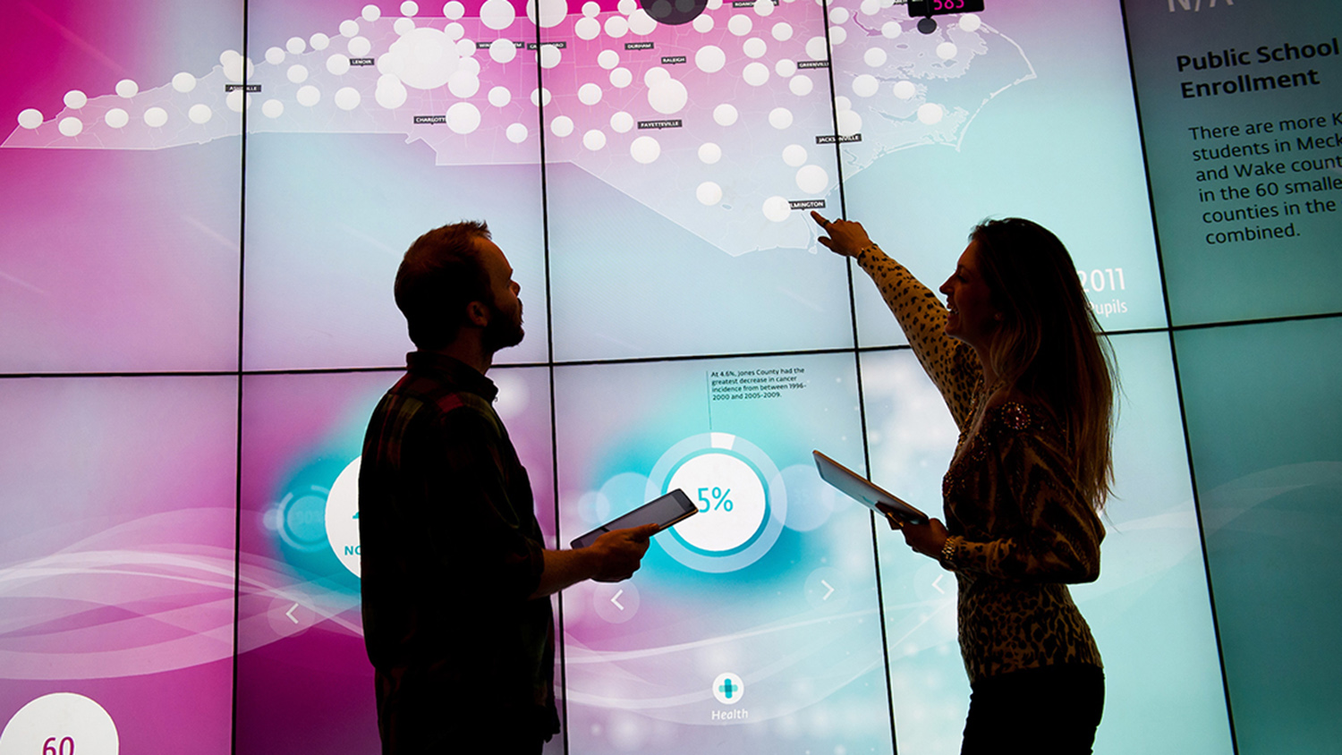 students pointing at screen in visualization lab