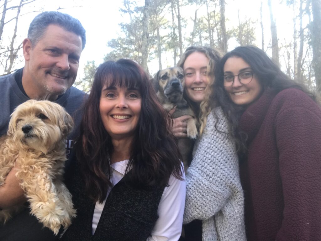 Shannon Fuller stands with family and two dogs