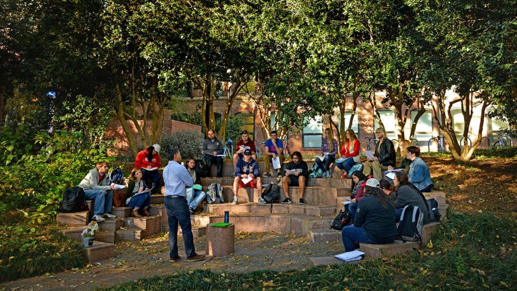 A professor teaches class at the outdoor classroom of the Court of North Carolina