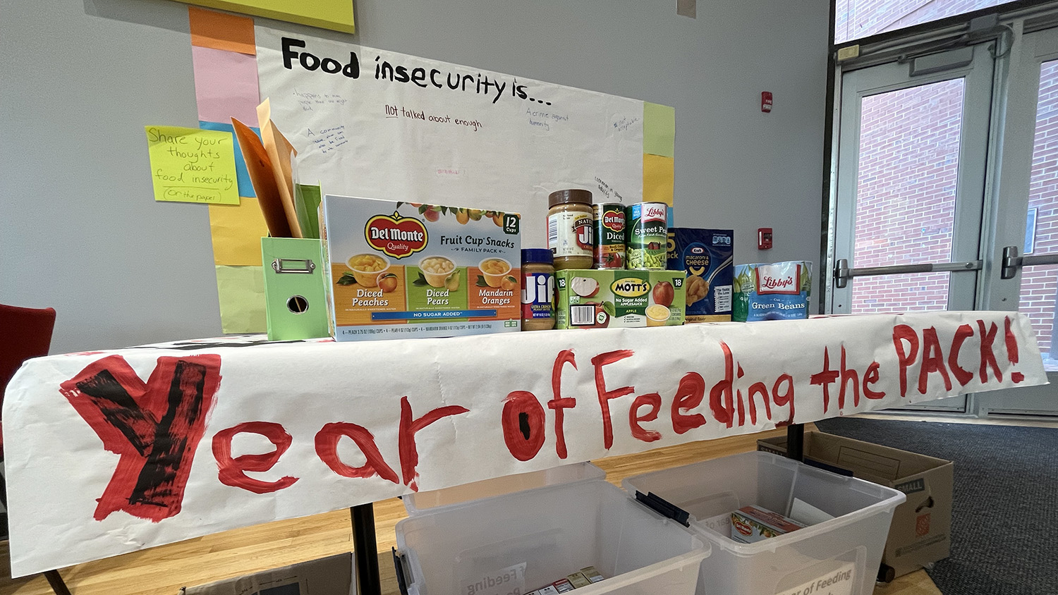 A sign reads, "Year of Feeding the Pack," in Caldwell Lounge
