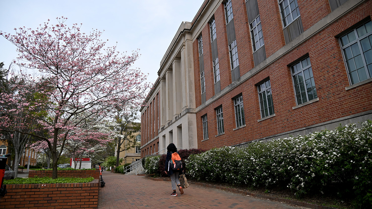 A student walks by Withers Hall.