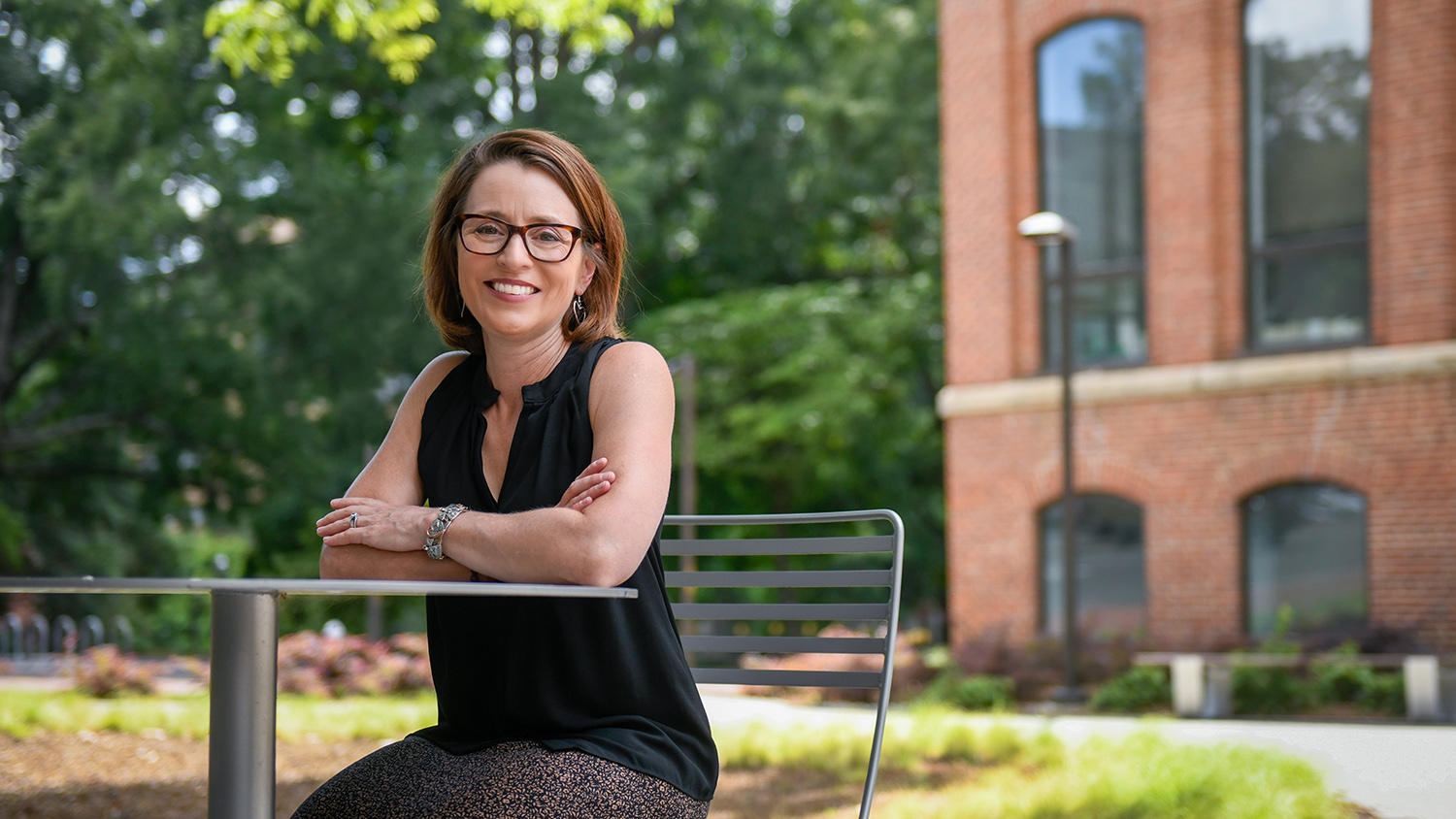 Dean Dannels sits at a table on NC State's campus.