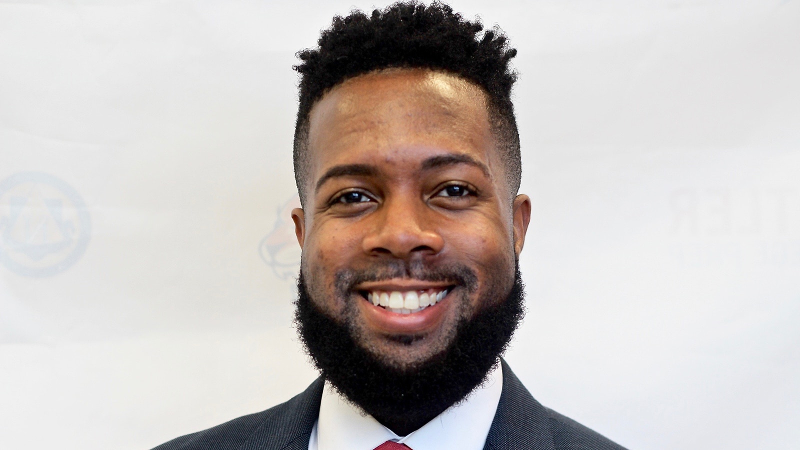 Brian Riddick smiles in a posed headshot.