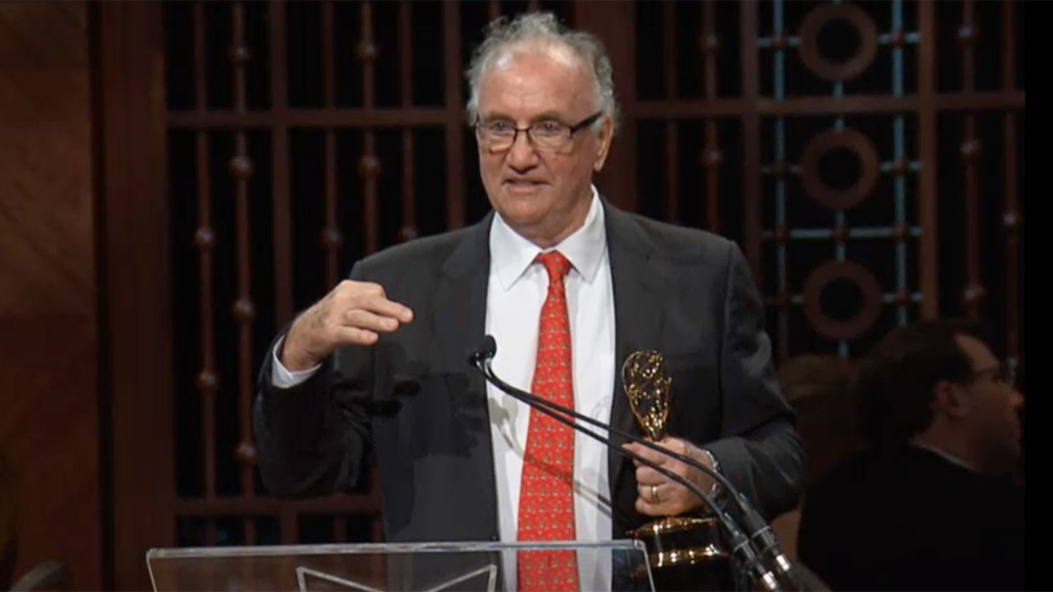 Walt Wolfram holding Emmy award