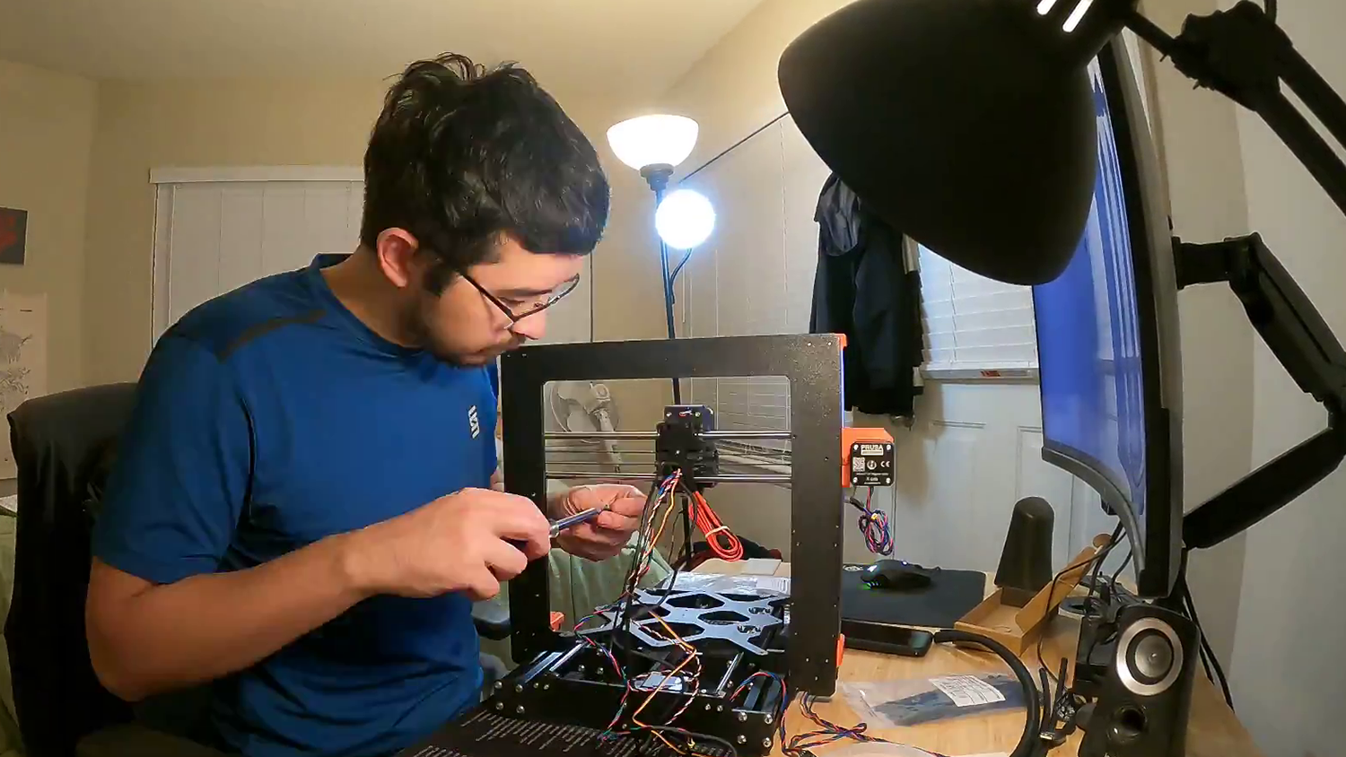 man wearing blue shirt working with wires